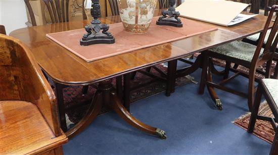 A George III style mahogany twin pillar dining table 208cm extended (one spare leaf)